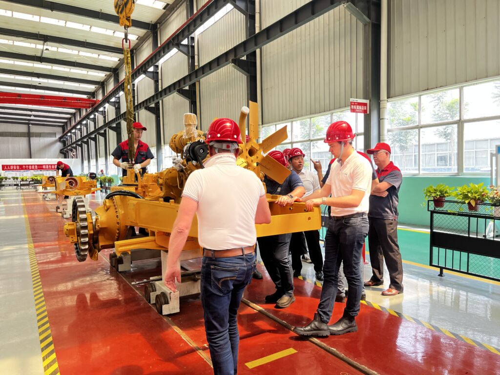 Clients were visiting our assembly line in the factory with stuff.